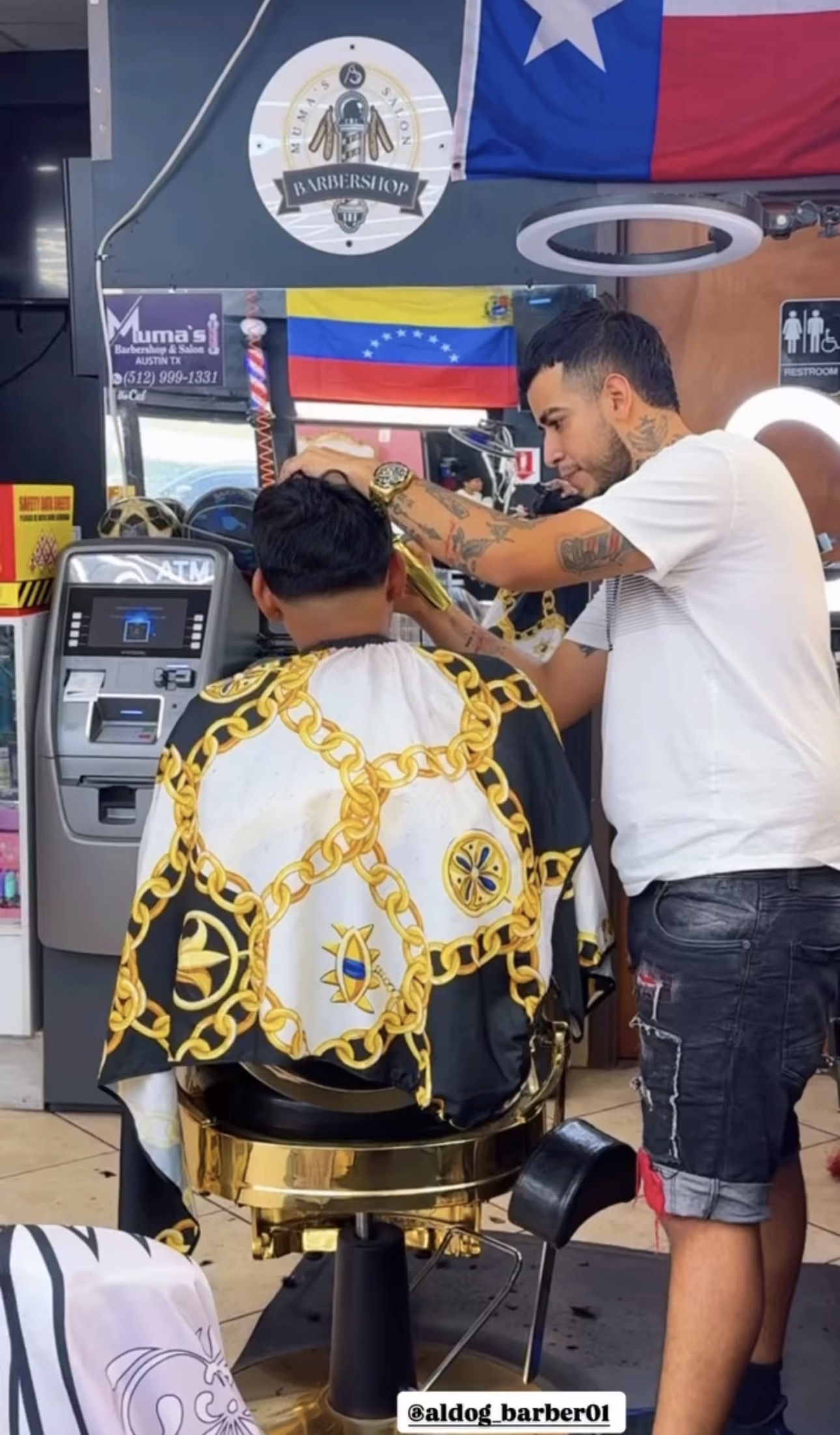 Barber at Muma's Barbershop giving a haircut
